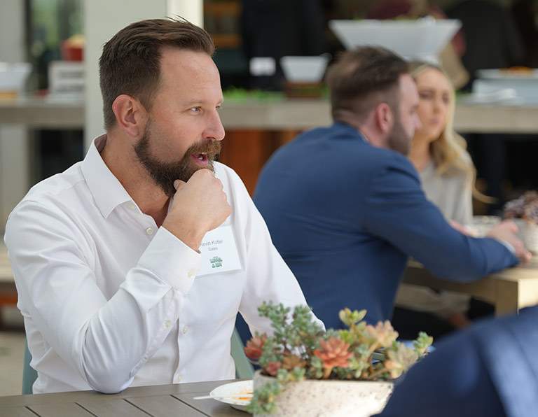 man with white shirt at a table